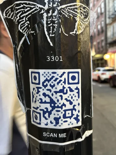 QR Code sticker on a curved pole showing how surface curvature distorts the code pattern